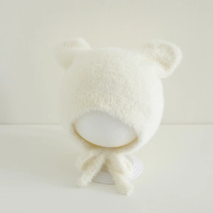 Detail of plush faux mink baby hat with cute bear ears and secure chin straps