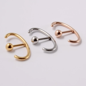Detailed view of C-shaped stainless steel ear studs in gold, silver, and rose gold finishes