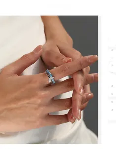 Detailed view of S925 silver mermaid tail ring with blue crystals on model finger
