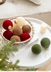 Détail de boules de Noël de 8 cm en velours floqué rouge et vert dans un panier
