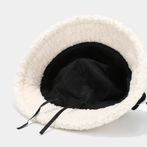 Cozy white faux shearling bucket hat with black inner lining and adjustable drawstring