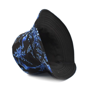 Detail of black bucket hat featuring blue bird and floral print with reinforced stitching