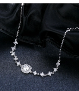 Macro shot of silver square moissanite pendant on luxury textured black background