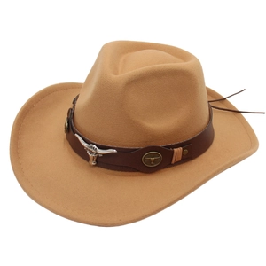 Detail of western cowboy hat featuring a leather band with bull head metal emblem