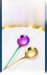 Close-up of golden and iridescent mirror polished stainless steel long handle spoons
