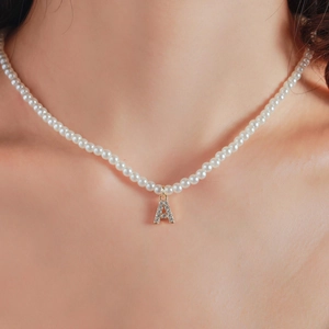 Faux pearl necklace with a gold-plated A-letter pendant and sparkling rhinestones
