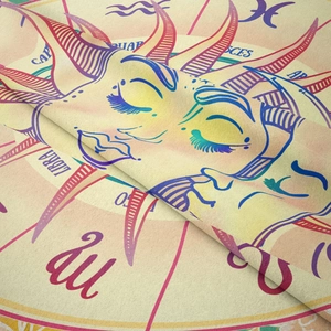 Detailed close-up of soft fabric texture featuring sun, moon, and zodiac constellation prints