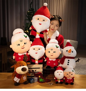 Detailed view of large plush Santa Claus doll held by a model in a warm festive setting