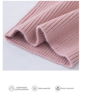 Close-up of pink cashmere knit fabric showing vertical ribbing texture and soft edges