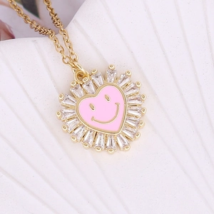 Gold necklace with pink heart smiley face pendant and crystal sunburst frame