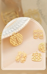 Close-up of golden Chinese Double Happiness alloy charm for wedding favor decoration