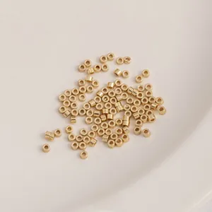Macro view of 14K gold plated cylindrical spacers for DIY jewelry making in ceramic tray