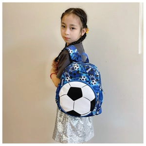 Side view of a blue kids football backpack worn by a model in a clean indoor setting