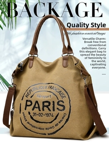 Macro shot of large khaki canvas tote bag featuring Paris text and brown leather handles