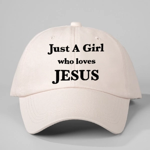 Pink baseball cap with Just A Girl who loves JESUS slogan on minimalist background