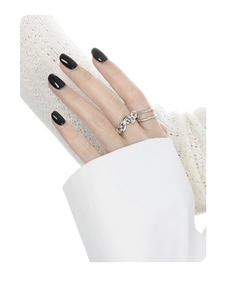 Detailed view of wavy S925 silver ring with light green gemstones on model's hand