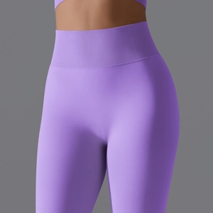 Detail of high-waisted seamless purple yoga pants with a supportive ribbed waistband