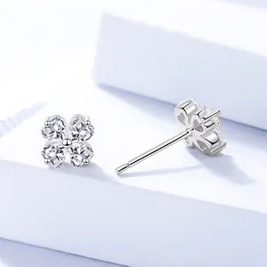 Elegant S999 silver four-leaf clover stud earrings with heart-cut clear zircon stones