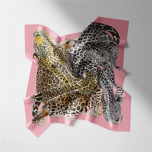 Detail of pink silk scarf featuring colorful leopard prints and artistic lazy typography