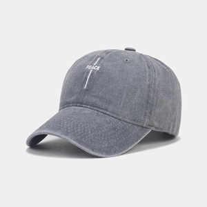 Close-up of PEACE embroidery on vintage washed grey cotton baseball cap texture
