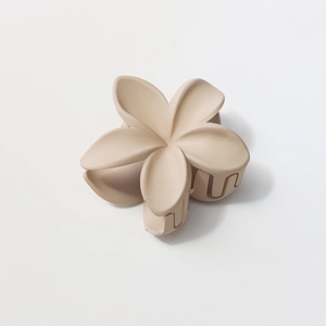 Macro shot of 8cm cream-colored matte flower hair claw with durable resin spring
