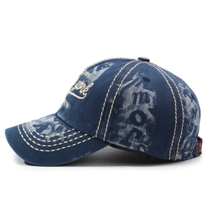 Vintage washed navy denim baseball cap with contrasting beige stitching and embroidery