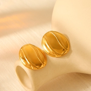 18k gold plated stainless steel wave texture oval earrings on beige ceramic decor