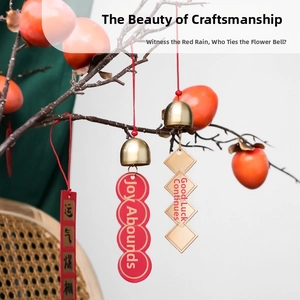 Close-up of decorative brass bells with Chinese lucky charms hanging on persimmon branches