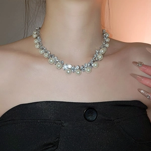 Close-up of elegant pearl and rhinestone necklace set worn on neck for a luxury look