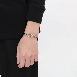 Close-up of a silver stainless steel paperclip and Cuban link bracelet with OT toggle clasp