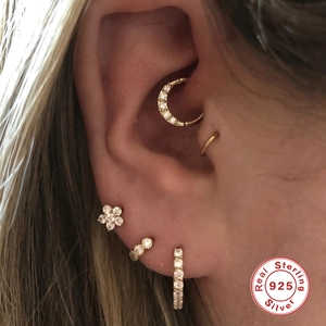 Close-up of S925 sterling silver gold earrings set with zircon moon and flower studs