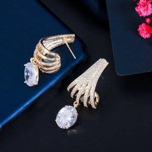 Detail of gold-plated earrings featuring a large oval zircon and pavé crystal accents