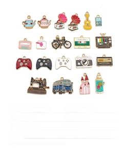 Macro shot of assorted retro enamel charms including camera and bicycle for DIY jewelry