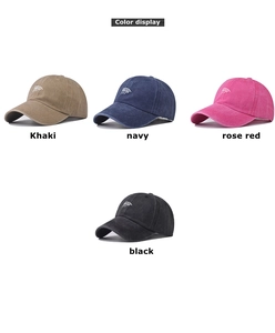 Detail view of washed cotton baseball caps in khaki, navy, rose red, and black finishes