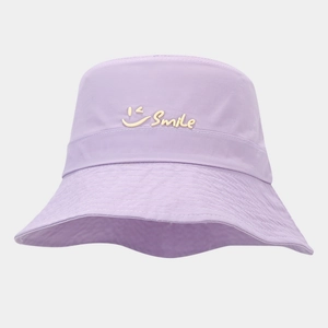 Detail view of the embroidered Smile text and wink icon on a purple summer bucket hat