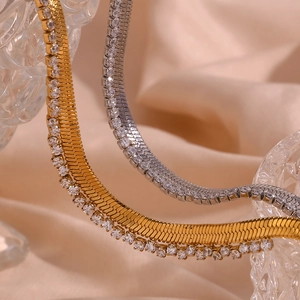 Detail of gold and silver herringbone chains with micro-inlaid cubic zirconia stones