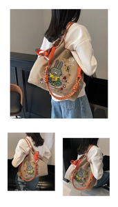 Detail of drawstring canvas backpack with cute rabbit print and orange woven straps