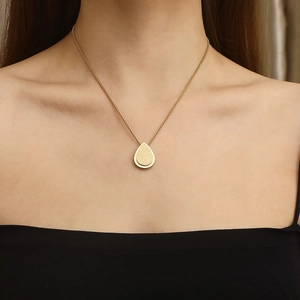 Elegant gold titanium necklace featuring a matte teardrop pendant on a fine metal chain