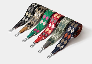 Close-up of assorted argyle pattern woven bag straps with metal hooks for handbags