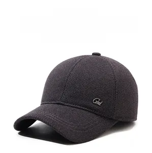 Detail of grey winter baseball cap with ear flaps and textured knit fabric texture