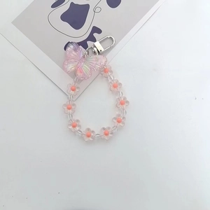 Close-up of pink gradient butterfly charm and transparent flower bead chain with clasp