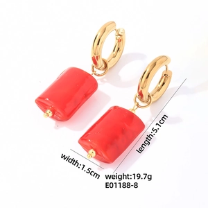 Detail view of gold hoop earrings with red rectangular stone pendants and measurements