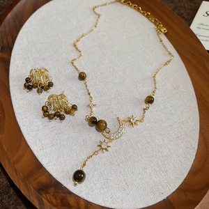 Tiger eye and zircon necklace earring set with gold celestial star and moon patterns