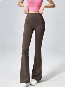 Detail van de bruine yoga-flarebroek met hoge taille, slanke pasvorm en gladde stofstructuur