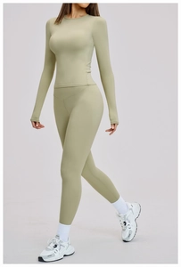 Detail of light green yoga set with long sleeve top and high waist leggings on model