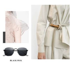 Close-up of black rimless sunglasses featuring sleek fashion cut edges and stylish details