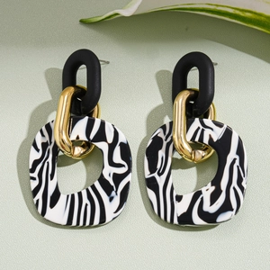 Modern geometric acrylic earrings with zebra stripe patterns and golden metal links