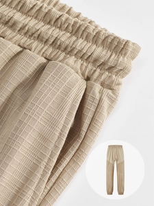 Detailed macro view of men's casual joggers featuring elastic drawstring waist and waffle texture
