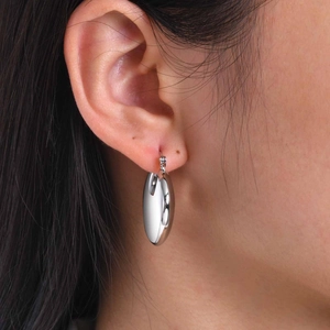 Detailed view of silver thick teardrop hoop earrings with high mirror-polished finish