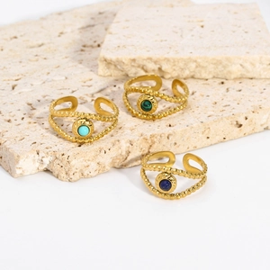 Detail of three adjustable 18K gold stainless steel rings with colorful natural stone eyes